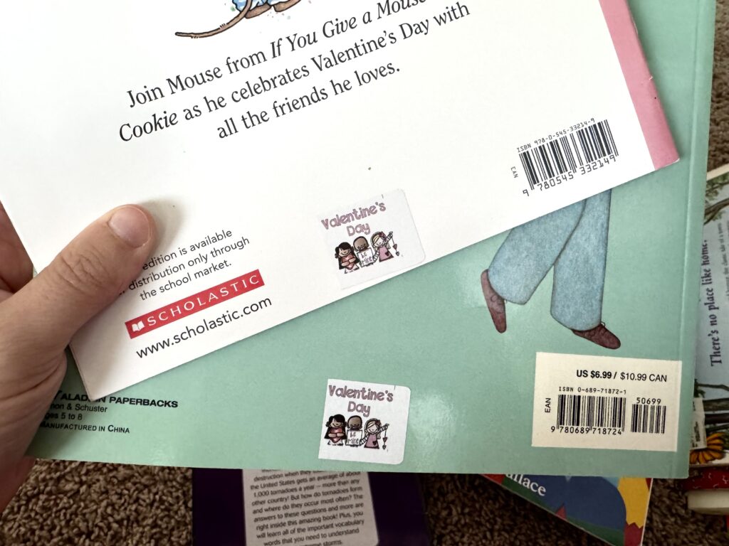Valentine Books with labels that say Valentine's day and a picture of kids with hearts