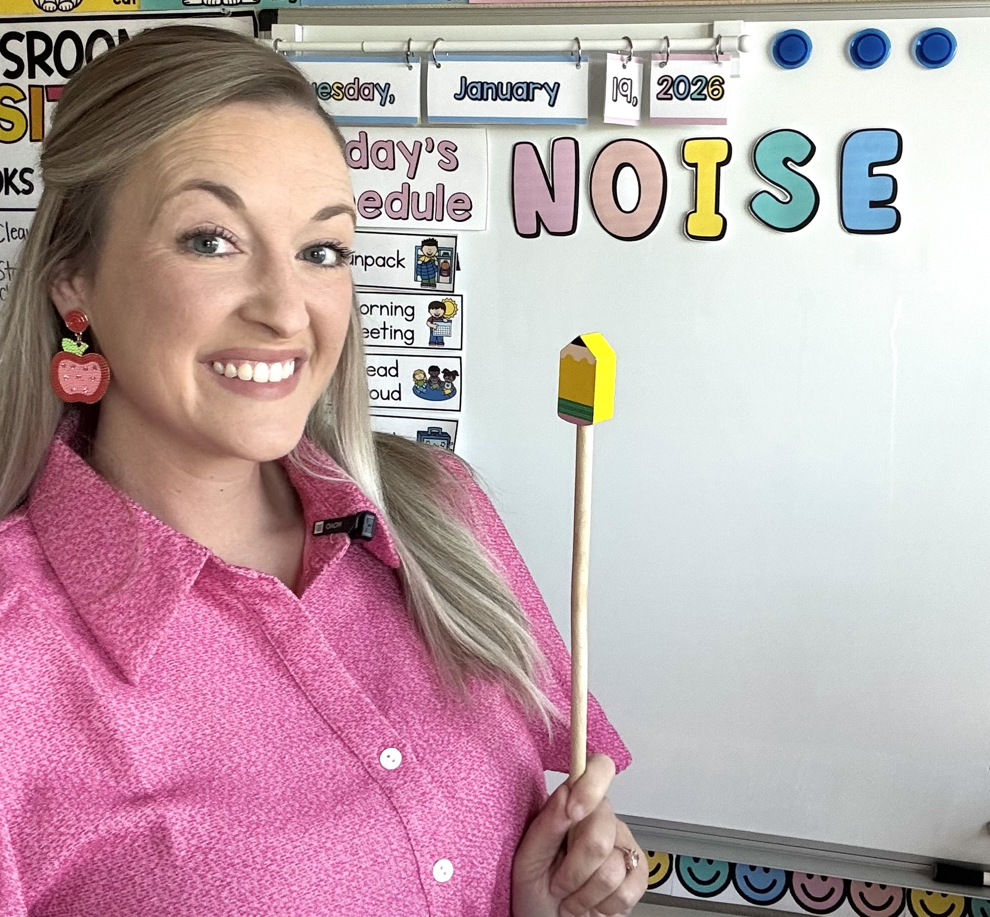 a teacher pointing to letters that spell NOISE