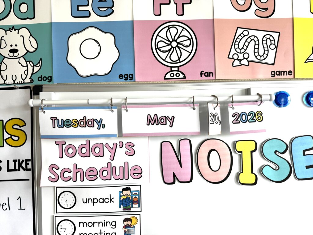 a whiteboard with a date hung on a magnet curtain rod that's an Amazon Teacher Find