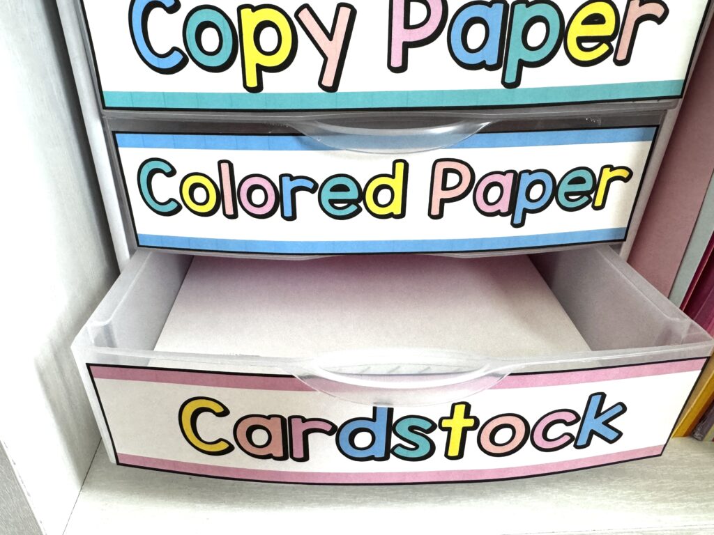 3 plastic drawers with labels "copy paper", "colored paper" and "cardstock" with the cardstock drawer open showing white cardstock